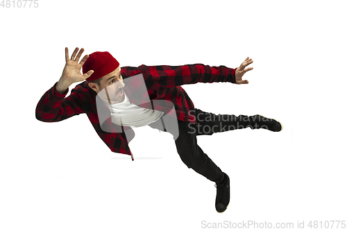 Image of A second before falling - young man falling down with bright emotions and expression