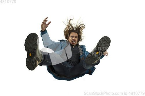 Image of A second before falling - young man falling down with bright emotions and expression