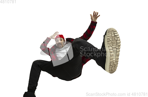 Image of A second before falling - young man falling down with bright emotions and expression