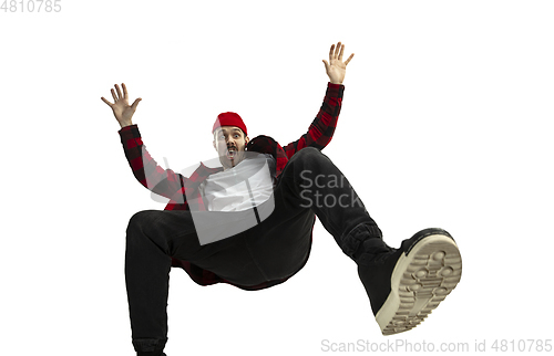 Image of A second before falling - young man falling down with bright emotions and expression