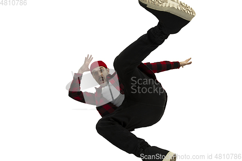 Image of A second before falling - young man falling down with bright emotions and expression