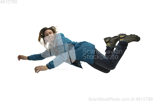 Image of A second before falling - young man falling down with bright emotions and expression