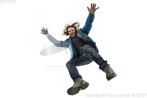 Image of A second before falling - young man falling down with bright emotions and expression