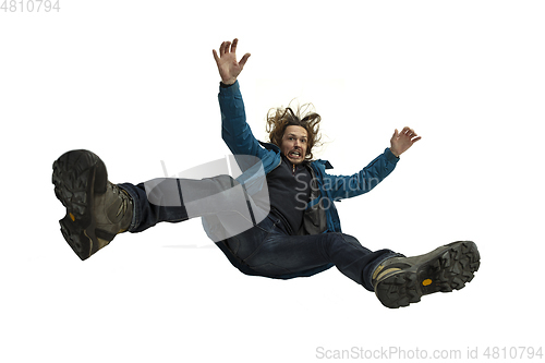 Image of A second before falling - young man falling down with bright emotions and expression