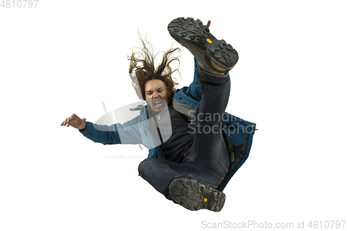 Image of A second before falling - young man falling down with bright emotions and expression