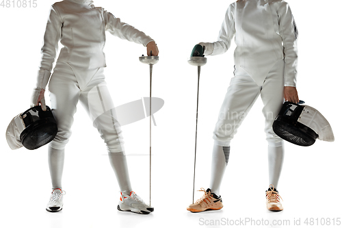 Image of Teen girls in fencing costumes with swords in hands isolated on white background