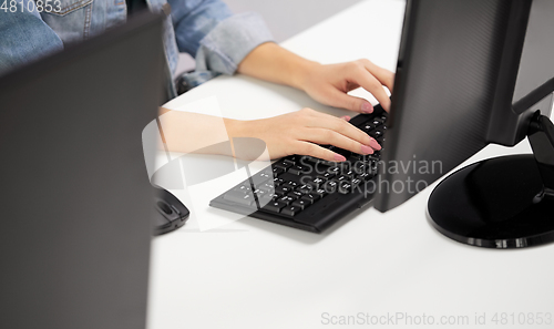 Image of female hands typing on computer keyboard