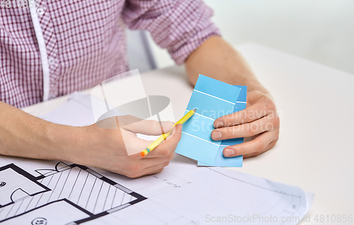 Image of architect with blueprint and color palettes