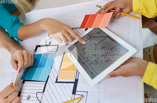 Image of close up of architects with blueprint on tablet pc