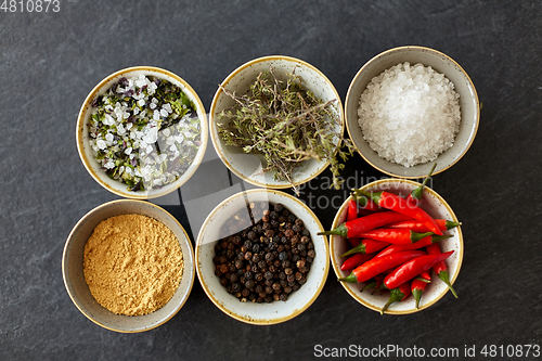 Image of bowls with different spices on slate stone table