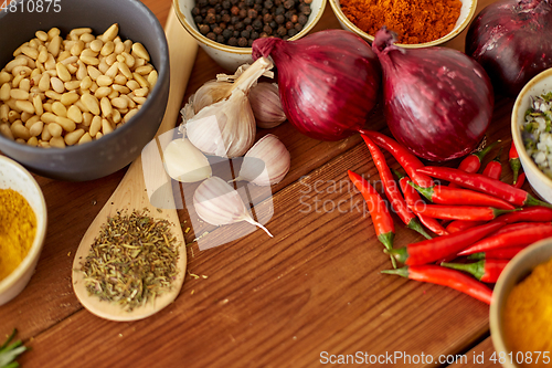 Image of spices, onion, garlic, pine nuts and chili peppers