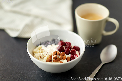 Image of porridge breakfast with berries, almonds and spoon