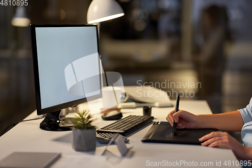 Image of designer with computer and pen tablet at office