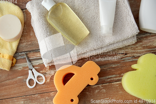 Image of baby accessories for bathing on wooden table