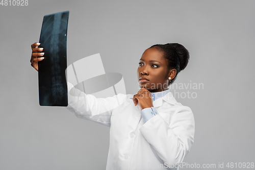 Image of african american female doctor looking at x-ray