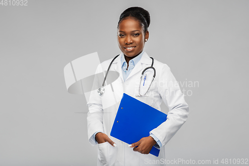 Image of happy african female doctor with clipboard