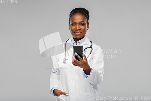 Image of african american female doctor with smartphone