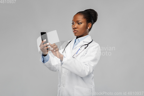 Image of african american female doctor with smartphone