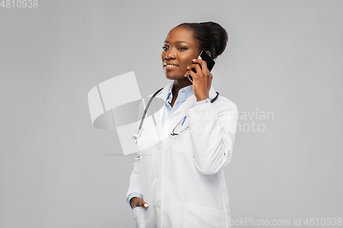 Image of african female doctor calling on smartphone