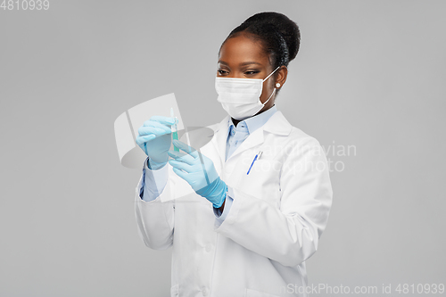 Image of african american female doctor with syringe