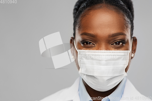 Image of african american female doctor in facial mask