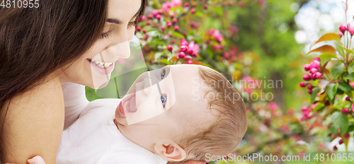 Image of mother with baby over spring garden background