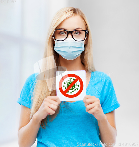 Image of woman in medical mask holding coronavirus sign