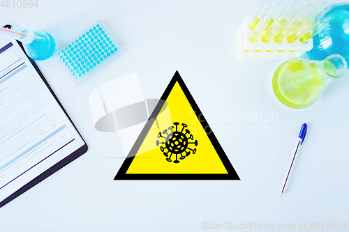 Image of coronavirus caution sign in scientific laboratory