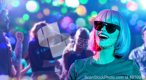 Image of happy woman in pink wig and sunglasses at party