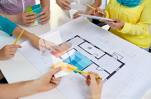 Image of close up of architects team working with blueprint