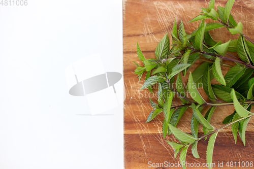 Image of bunch of fresh peppermint on wooden cutting board