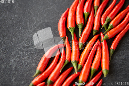 Image of red chili or cayenne pepper on slate stone surface