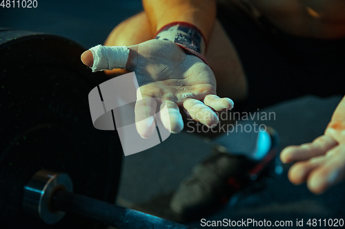 Image of Caucasian man practicing in weightlifting in gym
