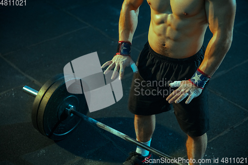 Image of Caucasian man practicing in weightlifting in gym