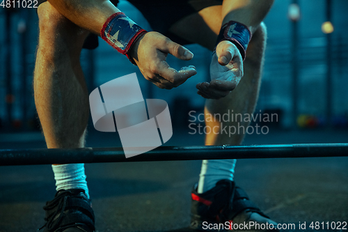 Image of Caucasian man practicing in weightlifting in gym