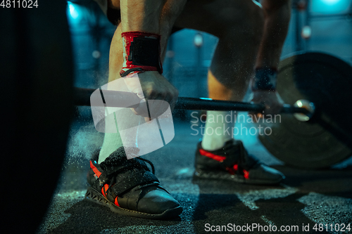 Image of Caucasian man practicing in weightlifting in gym