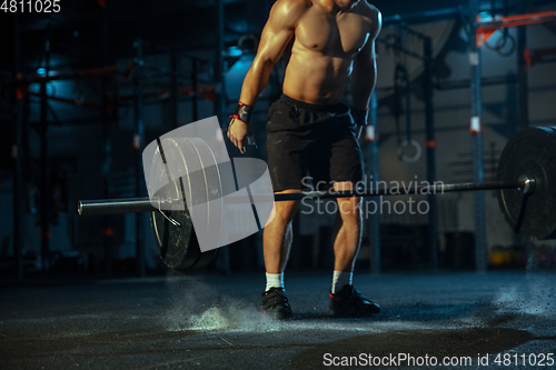 Image of Caucasian man practicing in weightlifting in gym