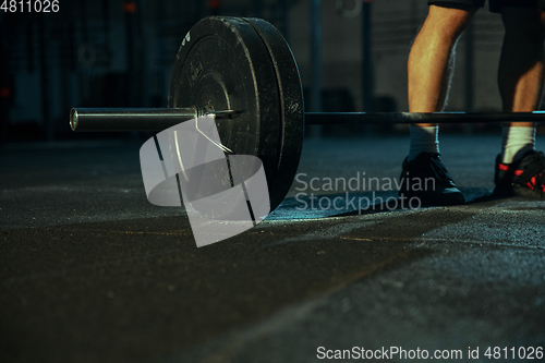 Image of Caucasian man practicing in weightlifting in gym