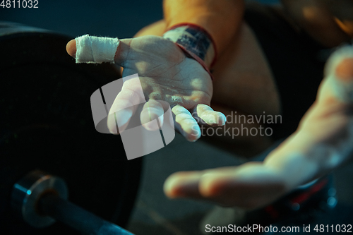 Image of Caucasian man practicing in weightlifting in gym