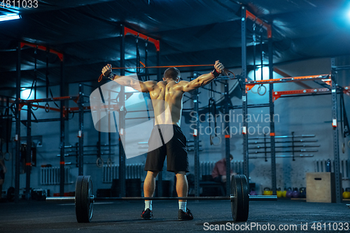 Image of Caucasian man practicing in weightlifting in gym