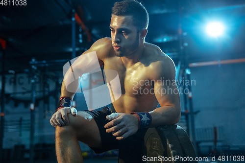 Image of Caucasian man practicing in weightlifting in gym