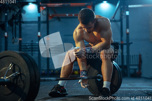 Image of Caucasian man practicing in weightlifting in gym