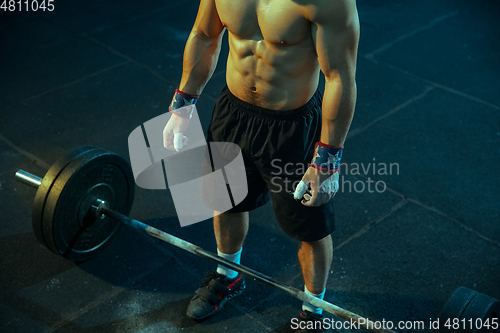 Image of Caucasian man practicing in weightlifting in gym