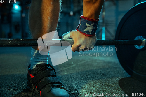 Image of Caucasian man practicing in weightlifting in gym