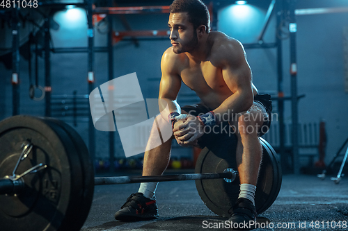 Image of Caucasian man practicing in weightlifting in gym