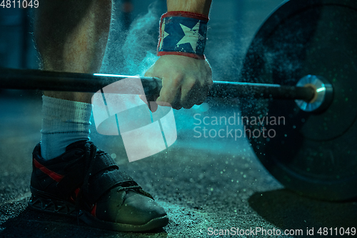 Image of Caucasian man practicing in weightlifting in gym