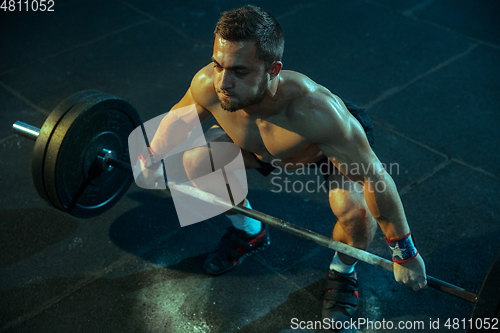 Image of Caucasian man practicing in weightlifting in gym