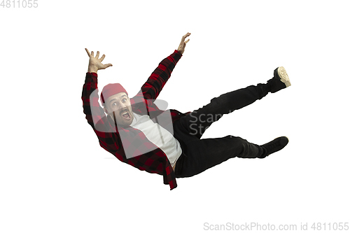 Image of A second before falling - young man falling down with bright emotions and expression