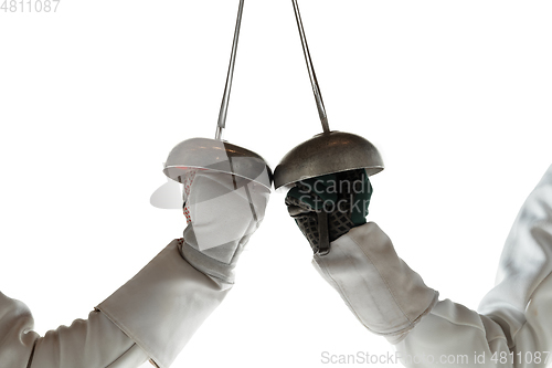 Image of Teen girls in fencing costumes with swords in hands isolated on white background