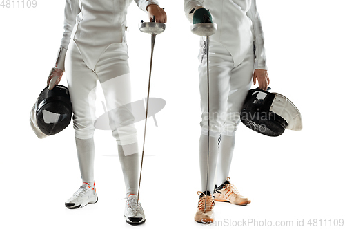 Image of Teen girls in fencing costumes with swords in hands isolated on white background